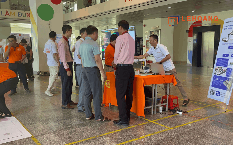 Đại biểu trải nghiệm cánh tay robot Dobot tại gian trưng bày Lê Hoàng Robotics trong sảnh trường Cao đẳng Viễn Đông